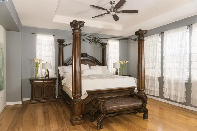 a bedroom with furniture and wooden floor