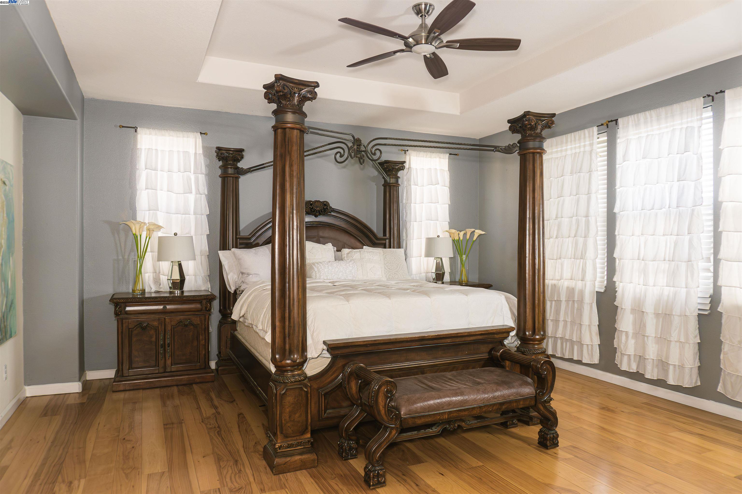 7064 Alder Creek Road Vallejo, CA 94591 - Photo 7 of 14 a bedroom with furniture and wooden floor