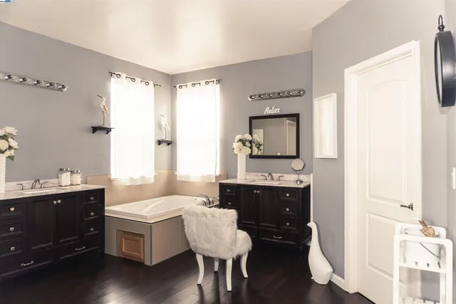 a spacious bathroom with a double vanity sink and a mirror