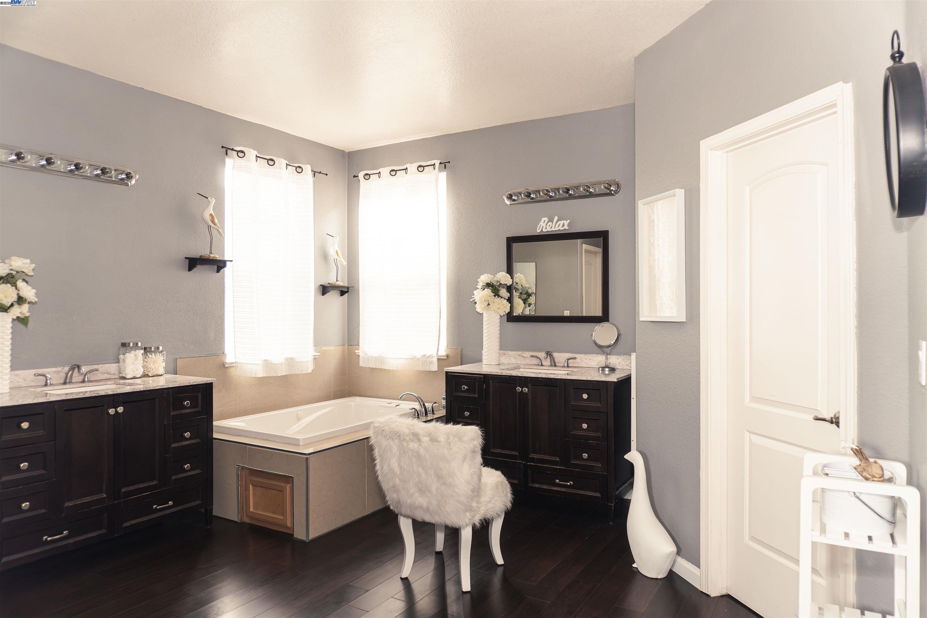 7064 Alder Creek Road Vallejo, CA 94591 - Photo 8 of 14 a spacious bathroom with a double vanity sink and a mirror