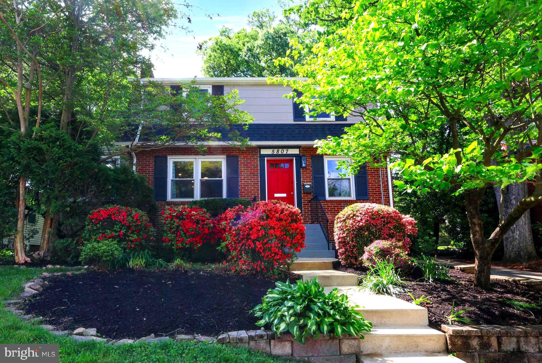 5807 Carlyle Street Cheverly, MD 20785 - Photo 2 of 58 a front view of a house with a yard and potted plants