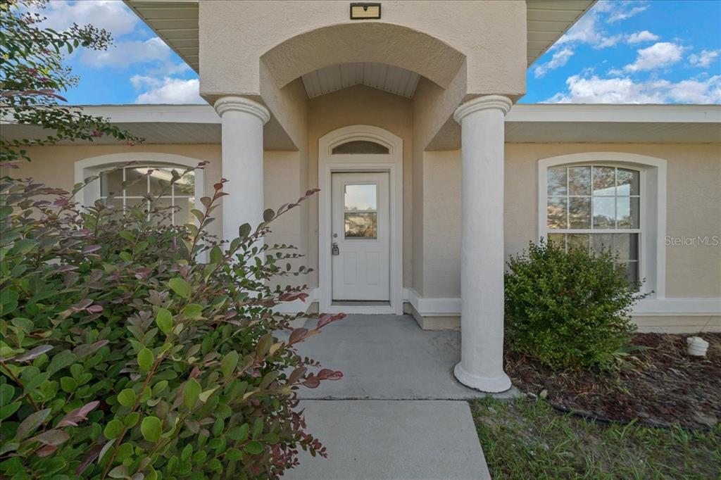 12205 Southeast 100th Court Belleview, FL 34420 - Photo 12 of 73 a front view of a house with garden