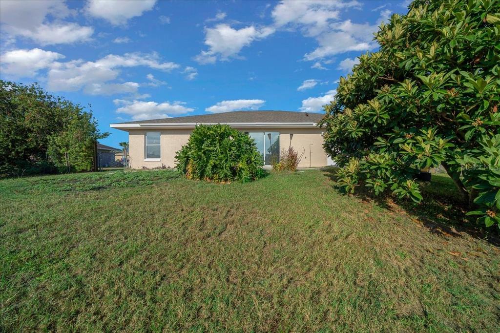 12205 Southeast 100th Court Belleview, FL 34420 - Photo 16 of 73 a view of backyard of house with green space