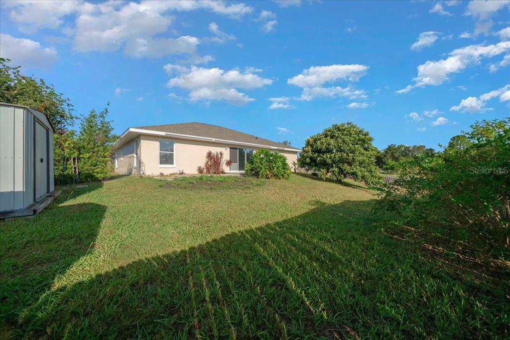 12205 Southeast 100th Court Belleview, FL 34420 - Photo 18 of 73 a view of a house with a big yard