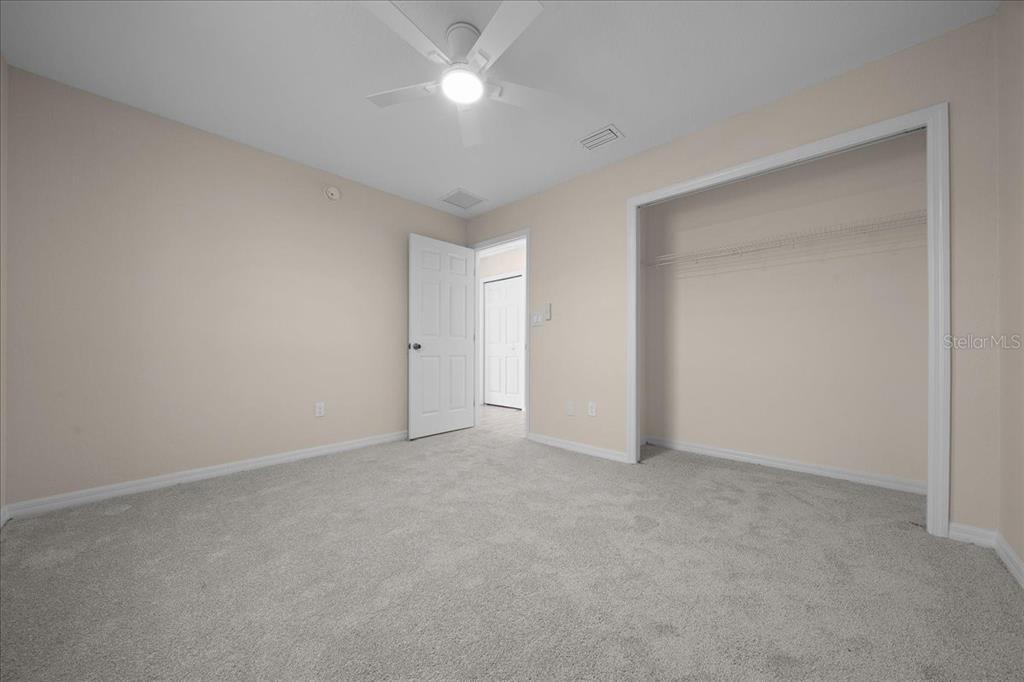 12205 Southeast 100th Court Belleview, FL 34420 - Photo 20 of 73 an empty room with a ceiling fan and a window