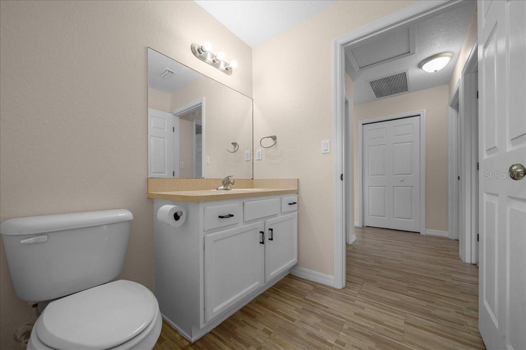 12205 Southeast 100th Court Belleview, FL 34420 - Photo 23 of 73 a bathroom with a toilet a sink and mirror