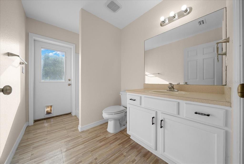 12205 Southeast 100th Court Belleview, FL 34420 - Photo 25 of 73 a bathroom with a sink a toilet and shower