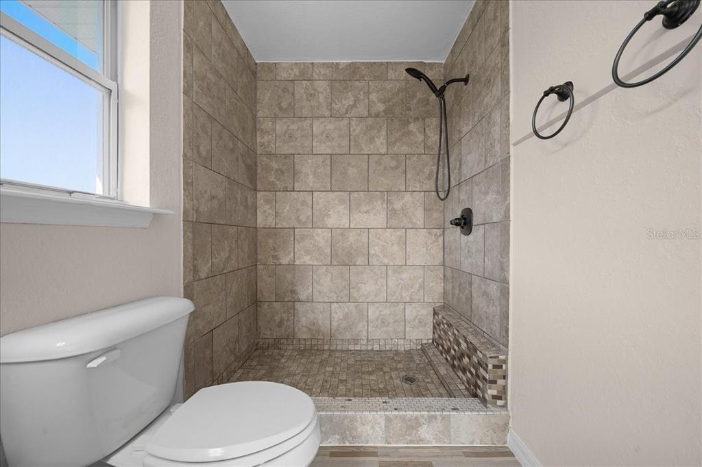 12205 Southeast 100th Court Belleview, FL 34420 - Photo 30 of 73 a white toilet sitting next to a bathroom sink