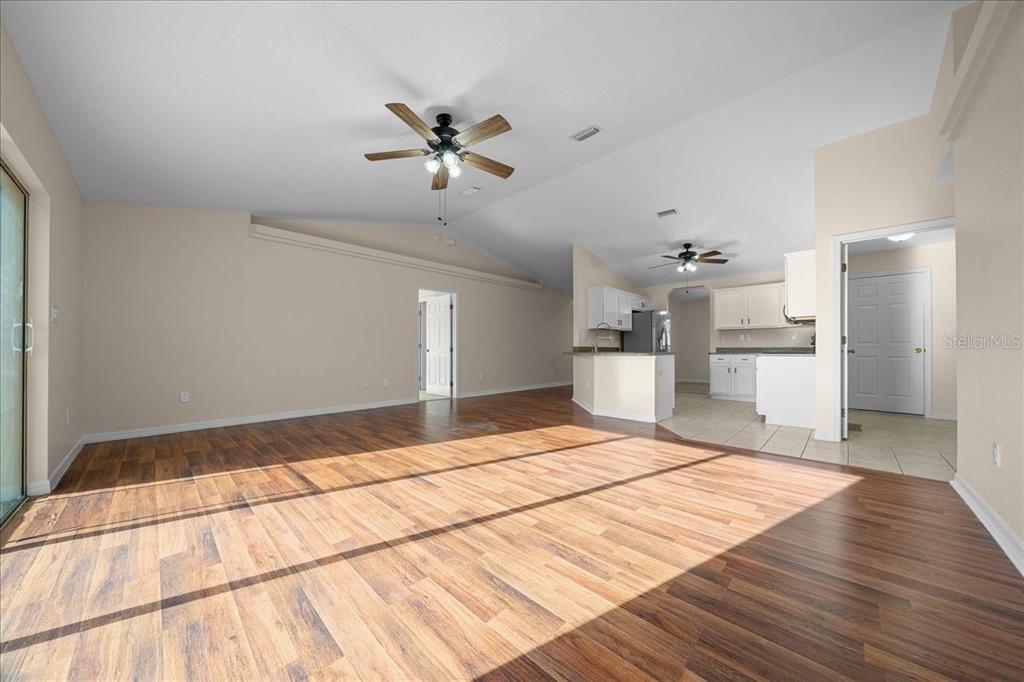 12205 Southeast 100th Court Belleview, FL 34420 - Photo 46 of 73 a bedroom with a bed and a chandelier