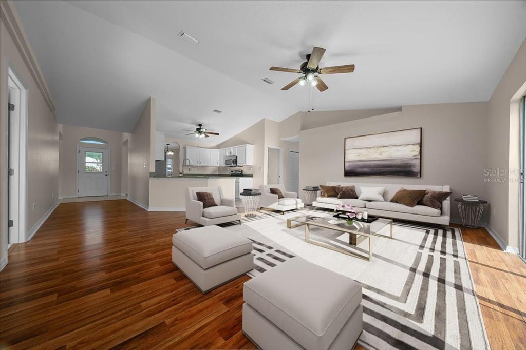 12205 Southeast 100th Court Belleview, FL 34420 - Photo 47 of 73 a living room with furniture and a flat screen tv
