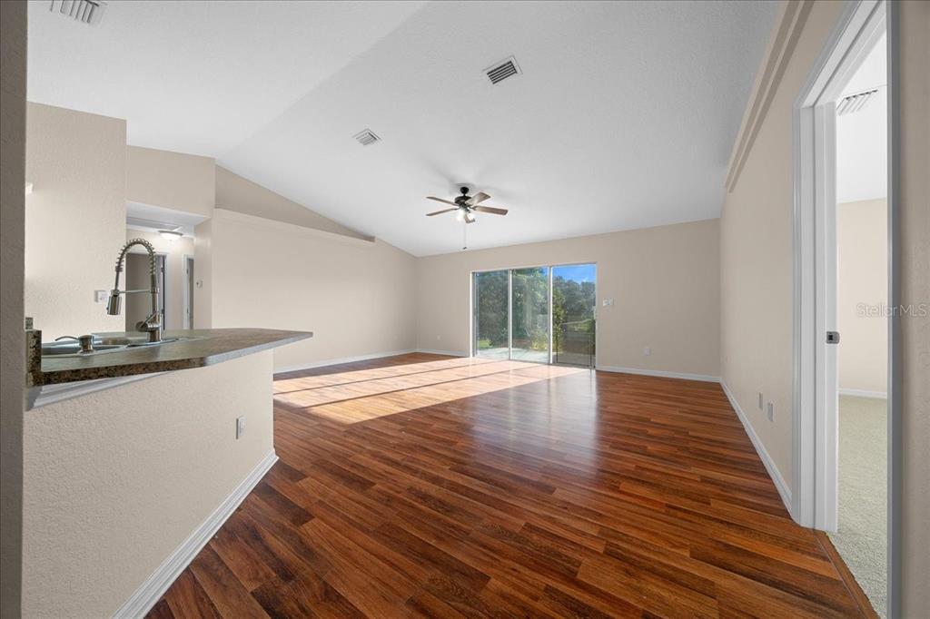 12205 Southeast 100th Court Belleview, FL 34420 - Photo 49 of 73 a view of a kitchen from the hallway
