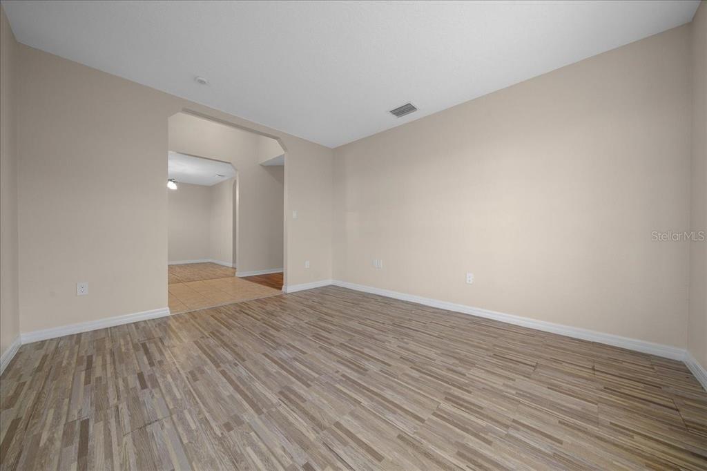 12205 Southeast 100th Court Belleview, FL 34420 - Photo 50 of 73 a view of an empty room with wooden floor and a window