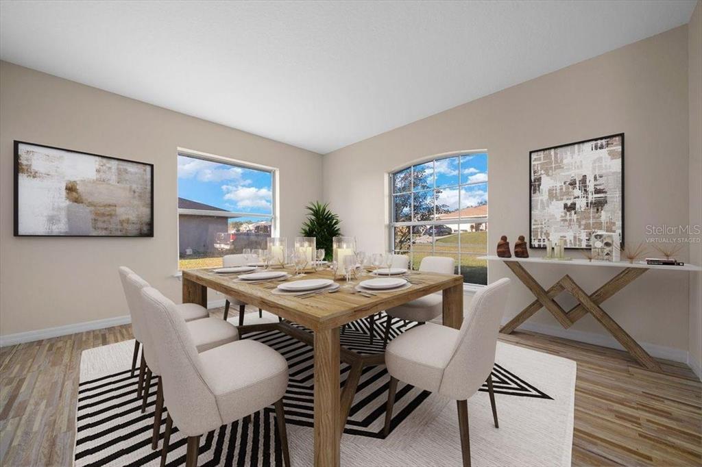 12205 Southeast 100th Court Belleview, FL 34420 - Photo 51 of 73 a view of a dining room with furniture and wooden floor