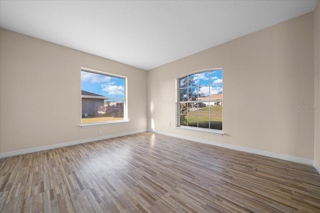 12205 Southeast 100th Court Belleview, FL 34420 - Photo 52 of 73 wooden floor in an empty room with a window