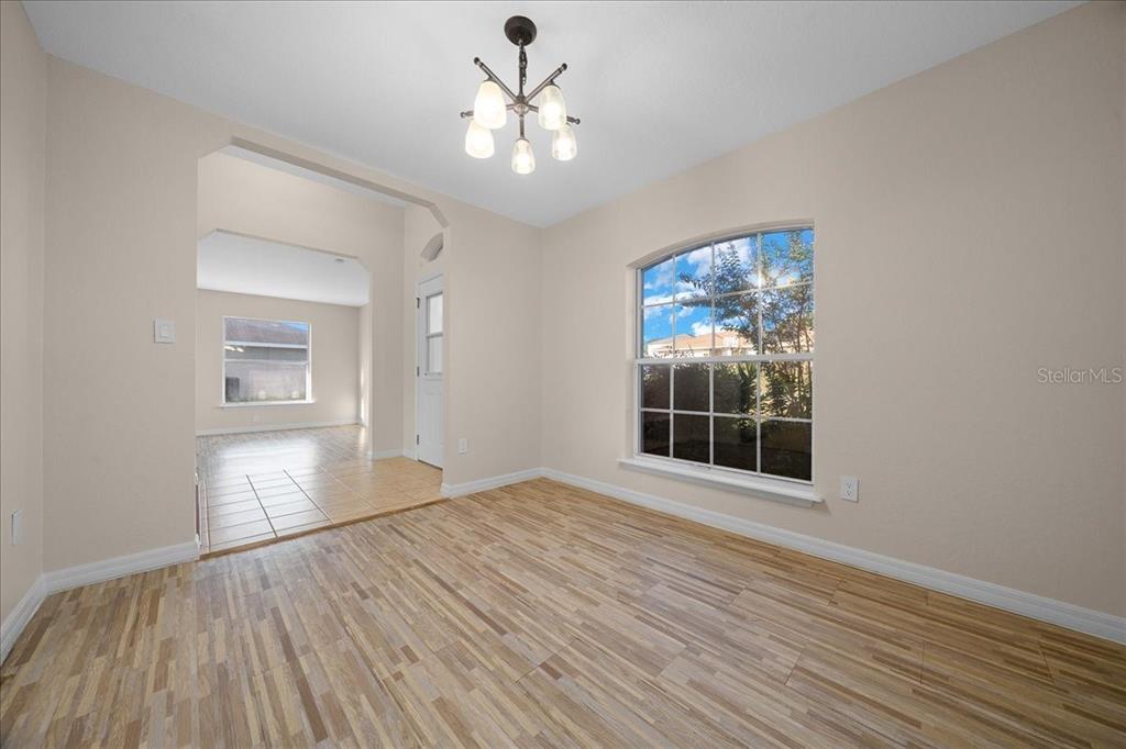 12205 Southeast 100th Court Belleview, FL 34420 - Photo 54 of 73 a view of empty room with wooden floor and fan