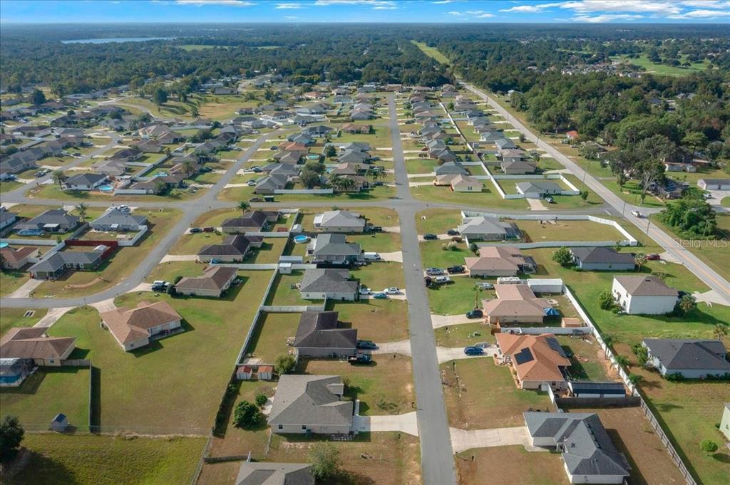 12205 Southeast 100th Court Belleview, FL 34420 - Photo 58 of 73 an aerial view of residential houses with outdoor space