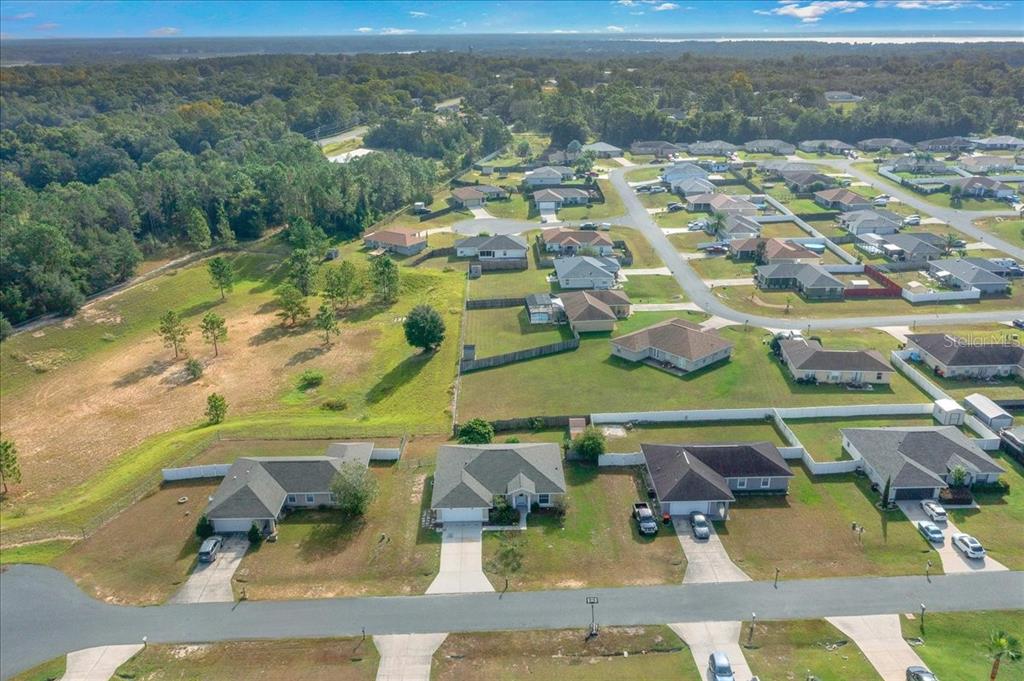 12205 Southeast 100th Court Belleview, FL 34420 - Photo 61 of 73 an aerial view of residential houses with outdoor space