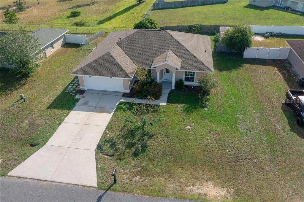12205 Southeast 100th Court Belleview, FL 34420 - Photo 67 of 73 an aerial view of a house with a yard