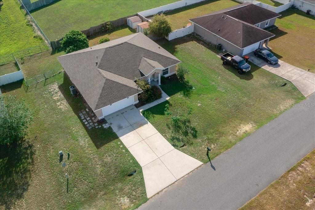 12205 Southeast 100th Court Belleview, FL 34420 - Photo 69 of 73 an aerial view of a house with a yard