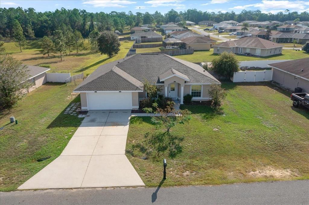 12205 Southeast 100th Court Belleview, FL 34420 - Photo 70 of 73 a aerial view of a house with a garden view