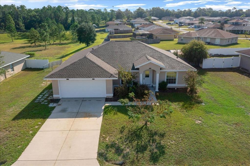 12205 Southeast 100th Court Belleview, FL 34420 - Photo 71 of 73 a aerial view of a house with a yard