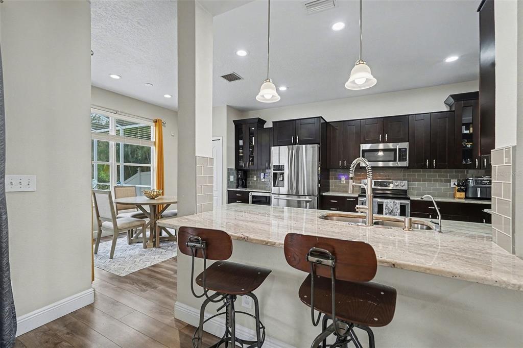 1952 Fruitridge Street Brandon, FL 33510 - Photo 14 of 39 a kitchen with stainless steel appliances kitchen island granite countertop a stove and a sink