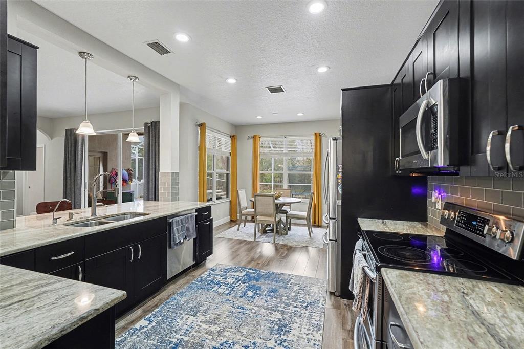 1952 Fruitridge Street Brandon, FL 33510 - Photo 15 of 39 a large kitchen with stainless steel appliances granite countertop a sink stove and refrigerator