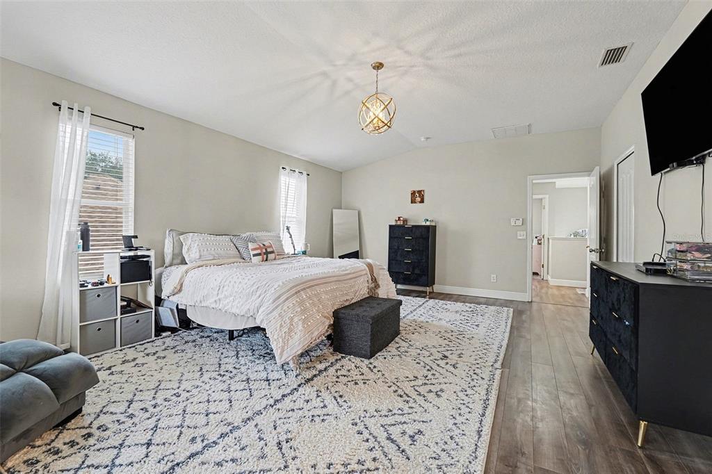 1952 Fruitridge Street Brandon, FL 33510 - Photo 20 of 39 a spacious bedroom with a bed a flat screen tv and dresser