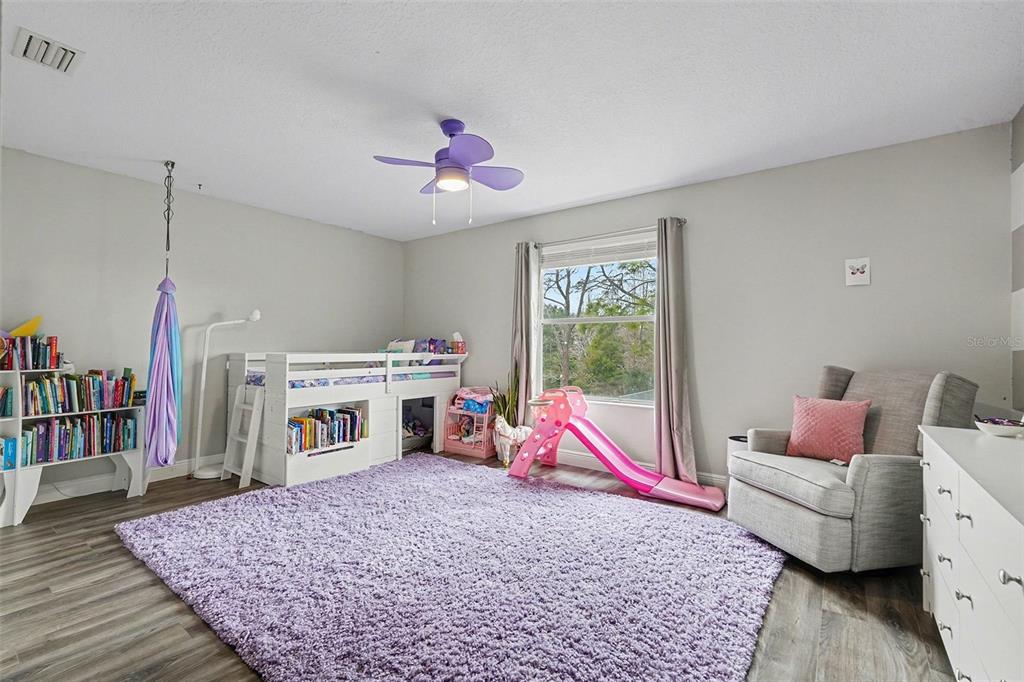 1952 Fruitridge Street Brandon, FL 33510 - Photo 27 of 39 a living room with furniture and a book shelf