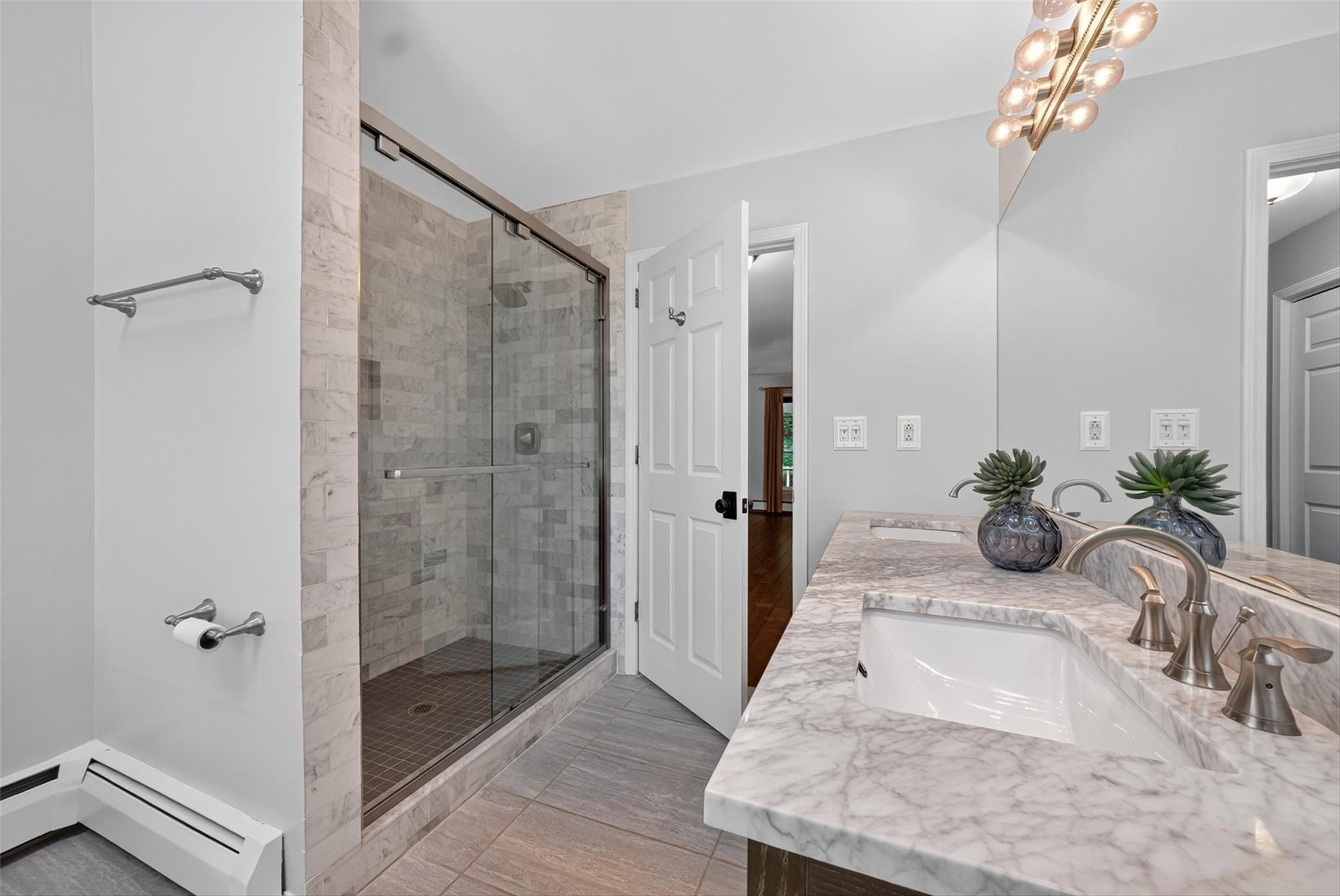 172 Shields Road Red Hook, NY 12571 - Photo 18 of 50 a bathroom with a granite countertop shower a mirror and a sink