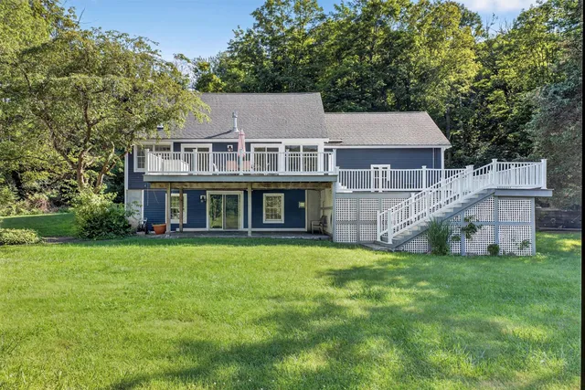 a view of a field with a tree in the background