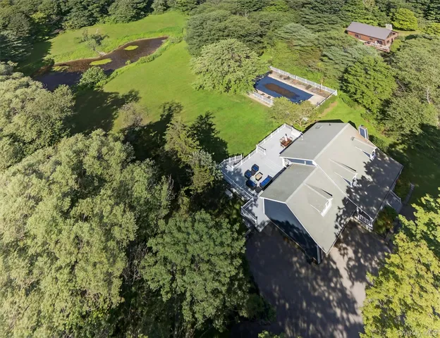an aerial view of a house with a yard