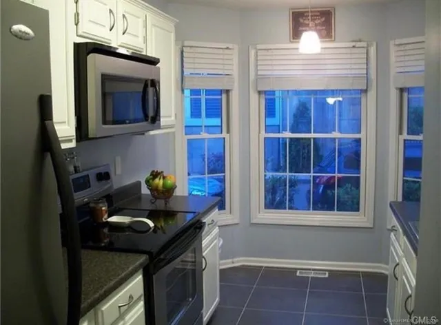 a kitchen with a sink cabinets and window