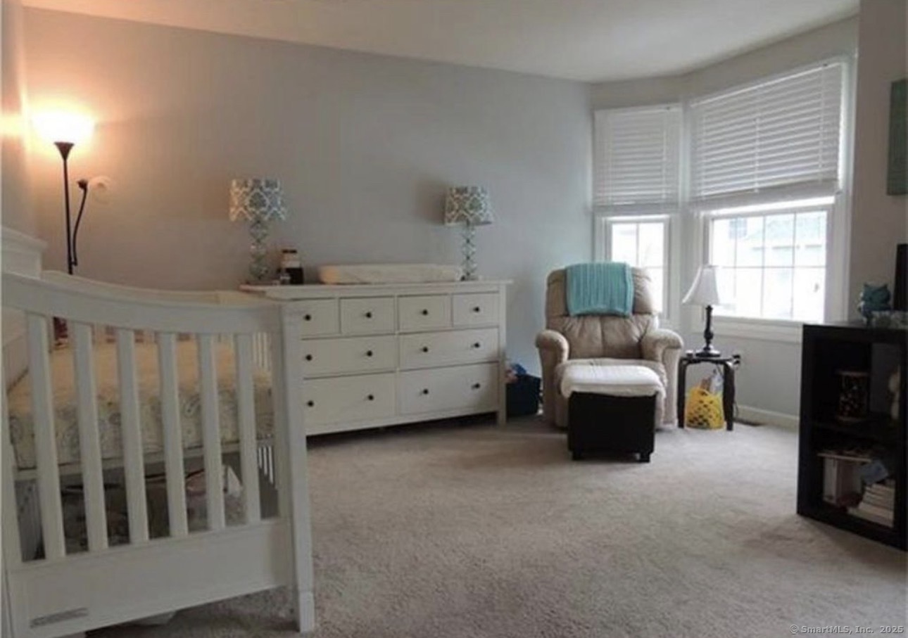 926 Quinnipiac Avenue, Unit 1 New Haven, CT 06513 - Photo 5 of 10 a bed room with furniture and a window