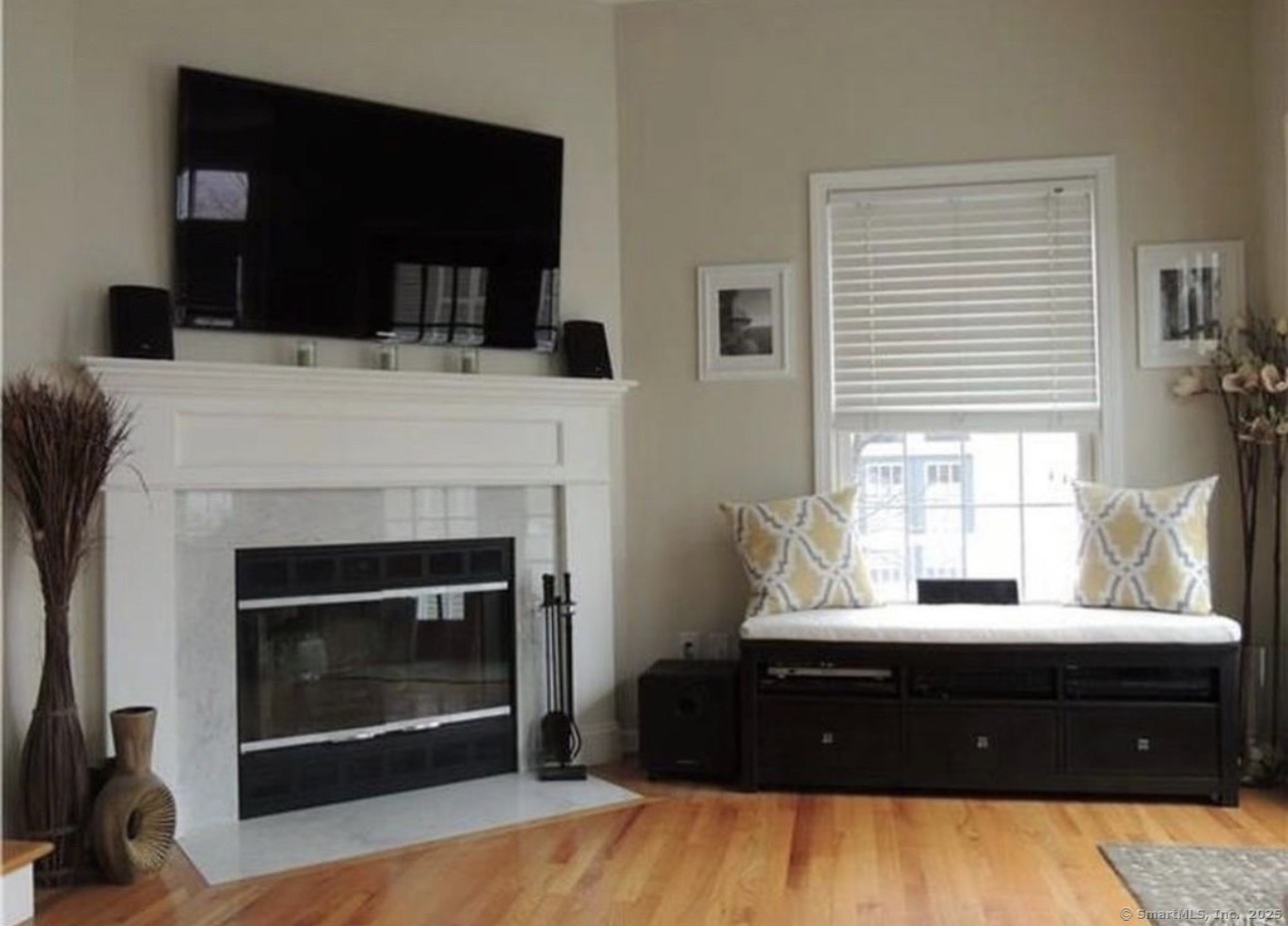 926 Quinnipiac Avenue, Unit 1 New Haven, CT 06513 - Photo 6 of 10 a living room with a fireplace and a flat screen tv