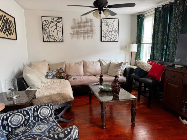 a living room with furniture and wooden floor