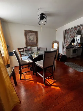 a dining room with furniture and wooden floor