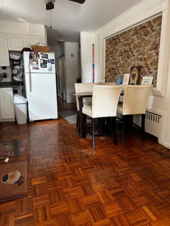 a room with wooden floor and large windows