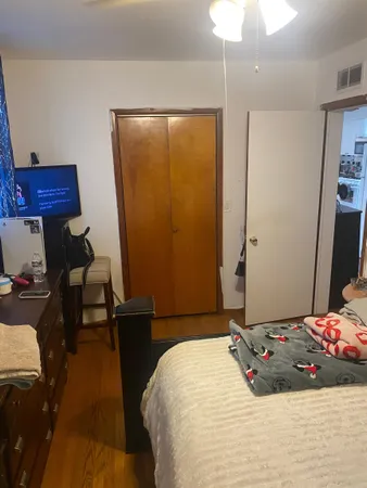 a bedroom with a bed and a chandelier