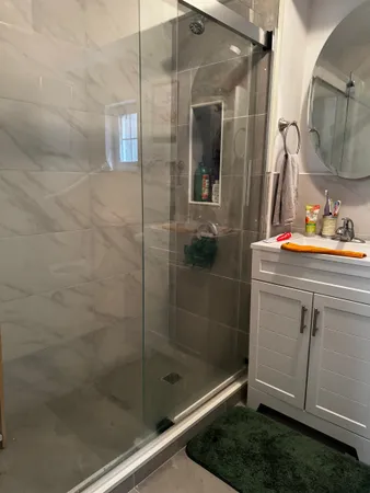 a bathroom with a shower and a sink
