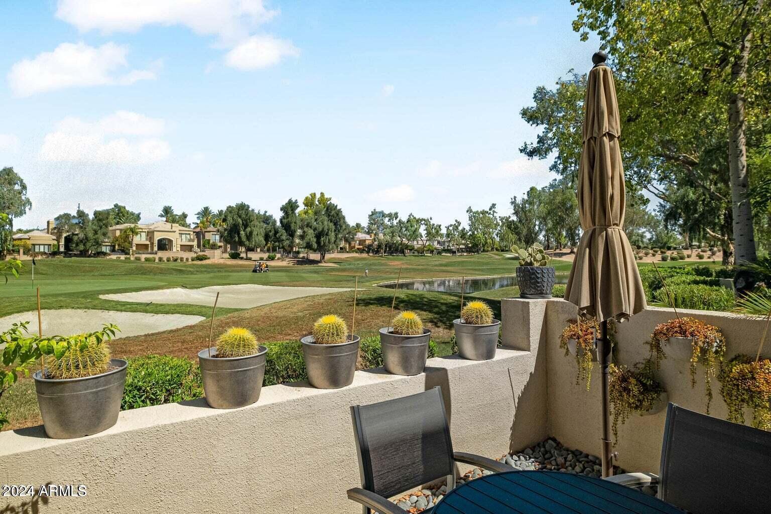 7272 East Gainey Ranch Road, Unit 43 Scottsdale, AZ 85258 - Photo 16 of 40 a view of a table and chairs in the garden