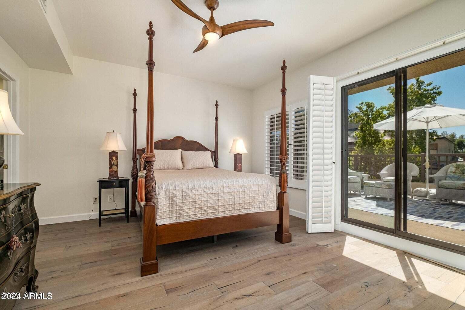 7272 East Gainey Ranch Road, Unit 43 Scottsdale, AZ 85258 - Photo 21 of 40 a bedroom with a bed and large window