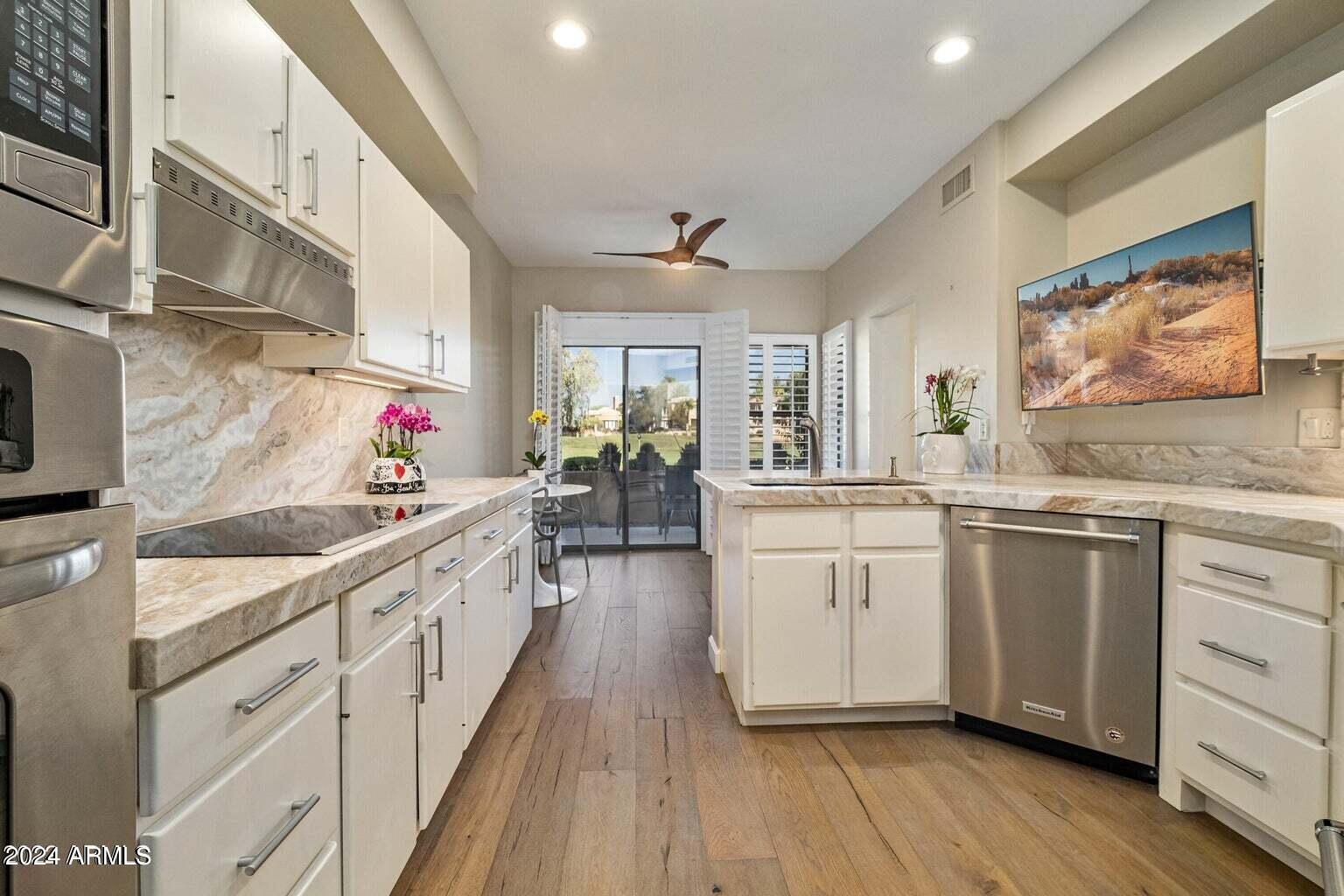 7272 East Gainey Ranch Road, Unit 43 Scottsdale, AZ 85258 - Photo 8 of 40 a kitchen with cabinets a sink and appliances