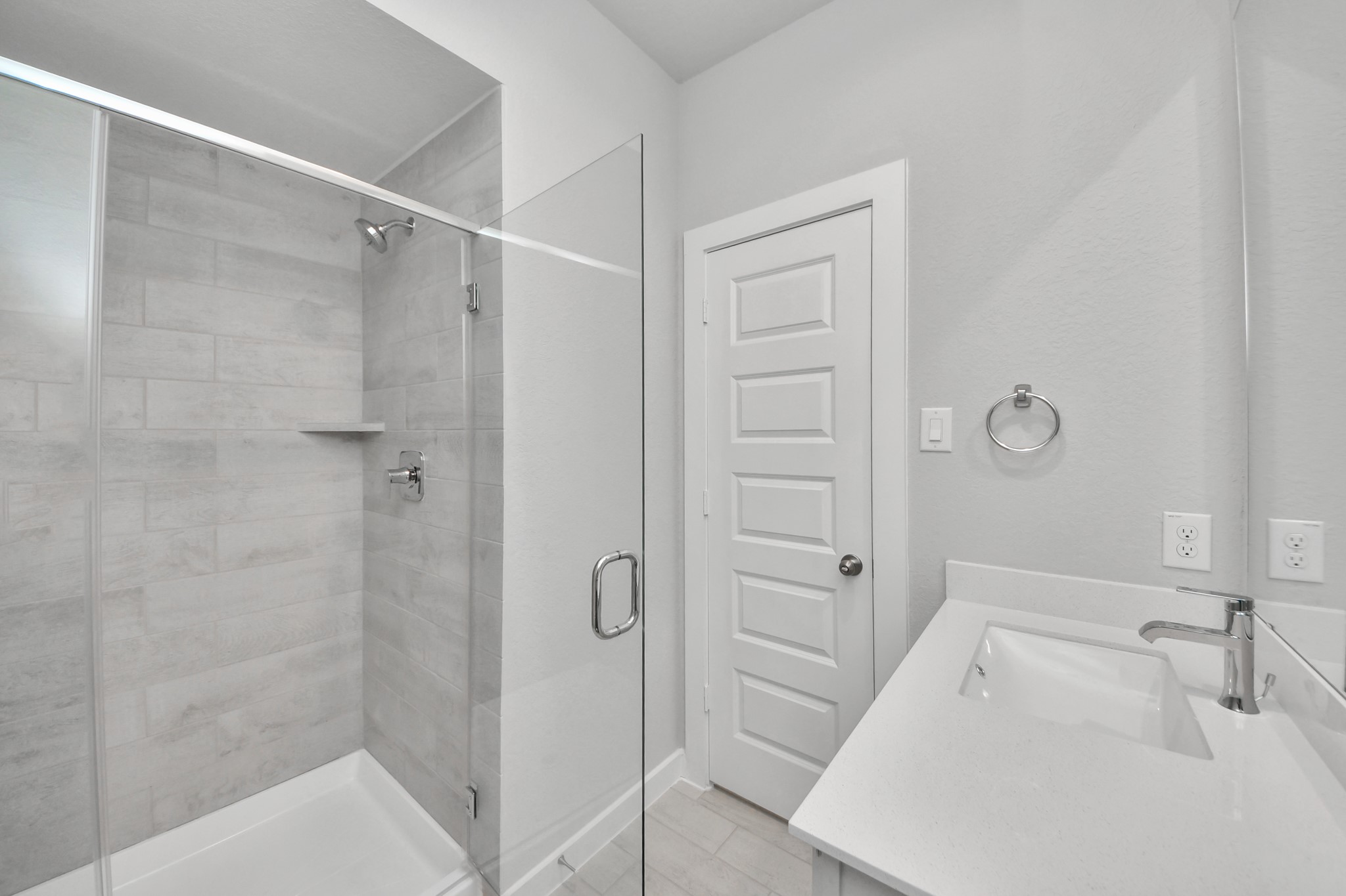11114 Tulip Rdg Trail Houston, TX 77044 - Photo 5 of 30 Secondary bath features tile flooring, walk-in shower with tile surround, light stained wood cabinets, beautiful light countertop. Sample photo of completed home with similar floor plan. Actual colors and selections may vary.