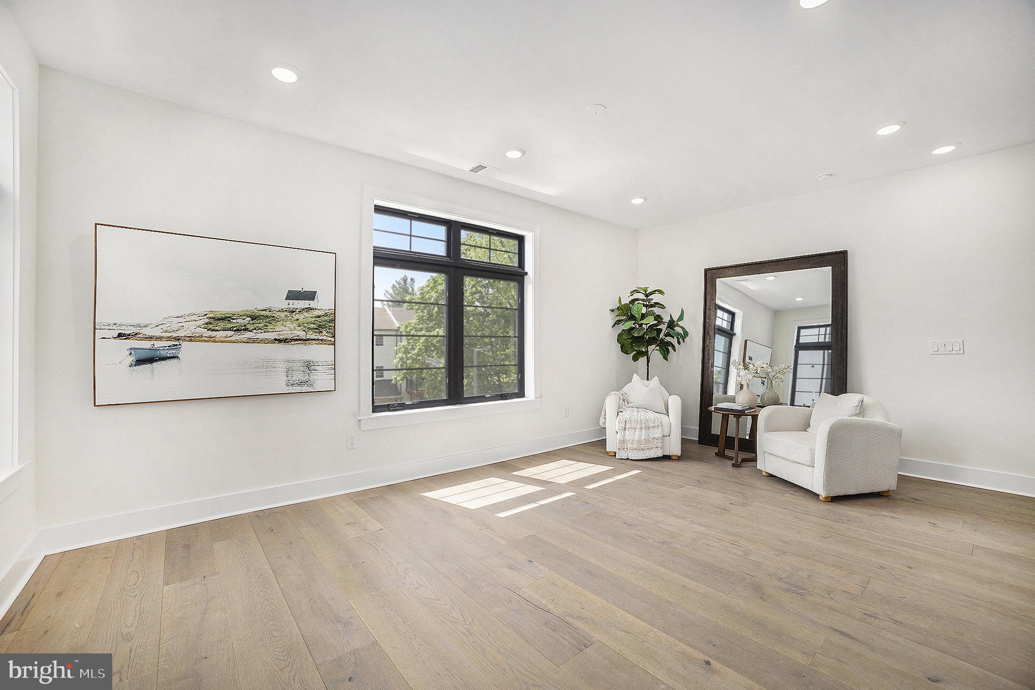 7519 Ridge Avenue, Unit 203 Philadelphia, PA 19128 - Photo 11 of 26 a view of an empty room with a window and wooden floor