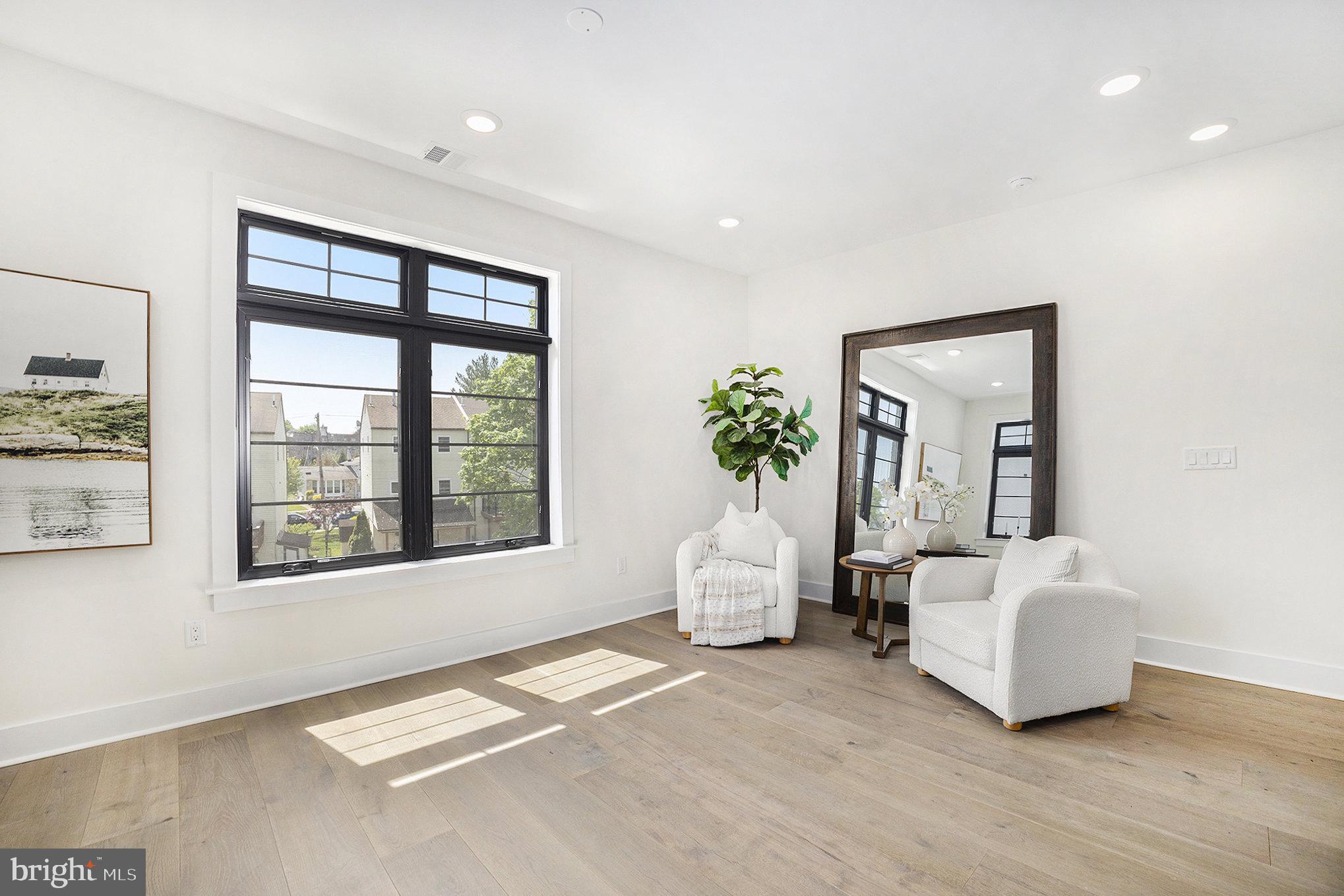 7519 Ridge Avenue, Unit 203 Philadelphia, PA 19128 - Photo 12 of 26 a living room with furniture and large windows