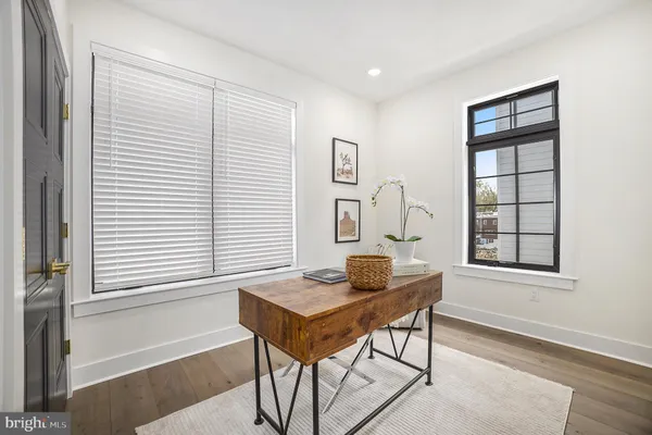 a view of a workspace with furniture and window