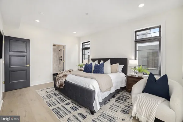 a bedroom with bed and wooden floor
