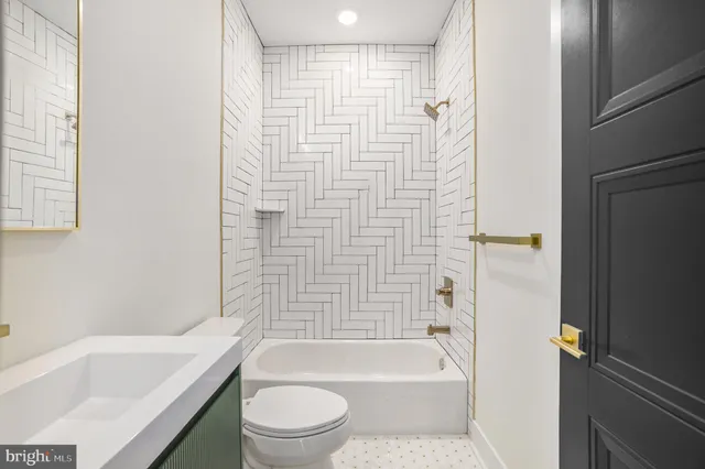 a bathroom with a bathtub toilet and sink