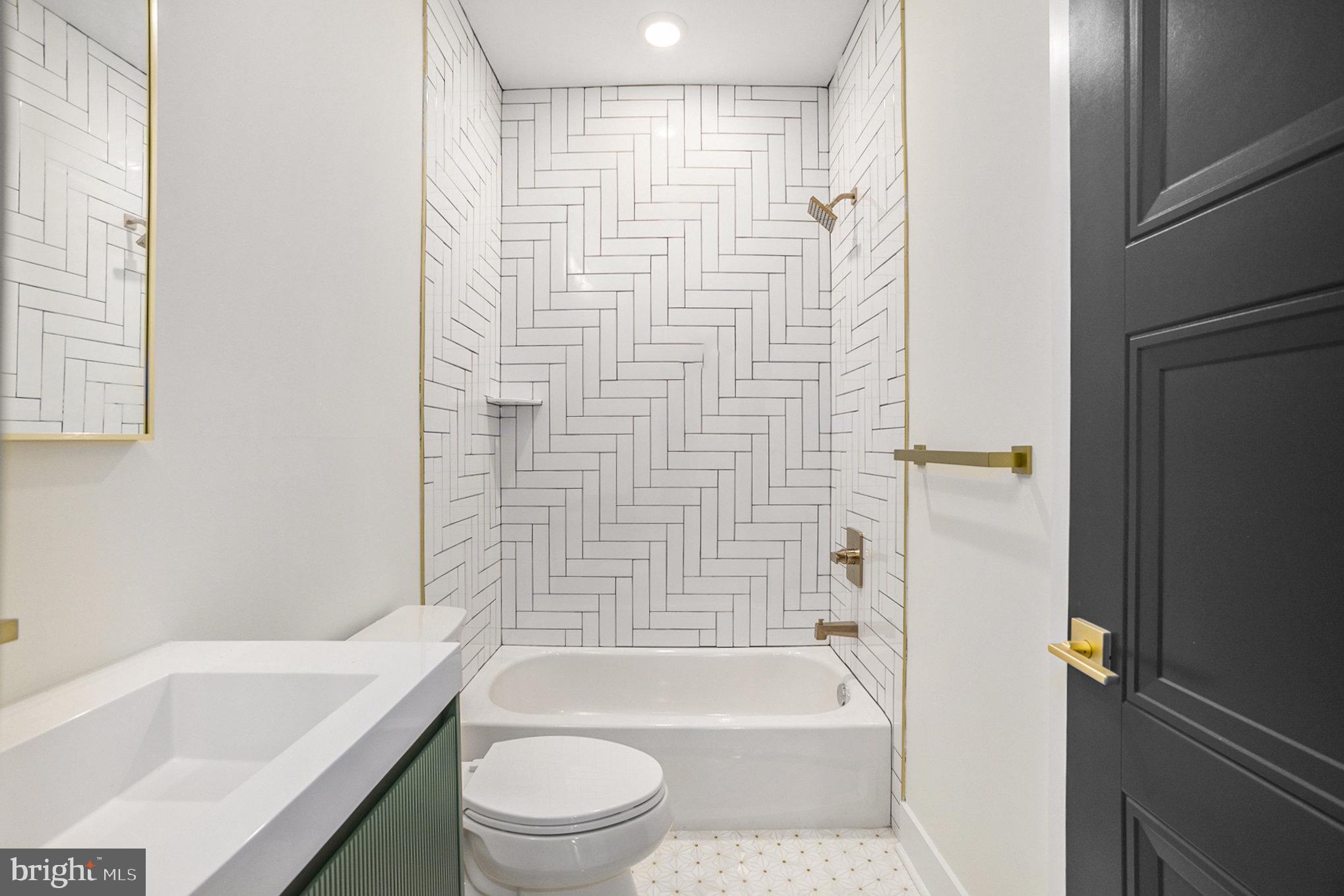 7519 Ridge Avenue, Unit 203 Philadelphia, PA 19128 - Photo 23 of 26 a bathroom with a bathtub toilet and sink